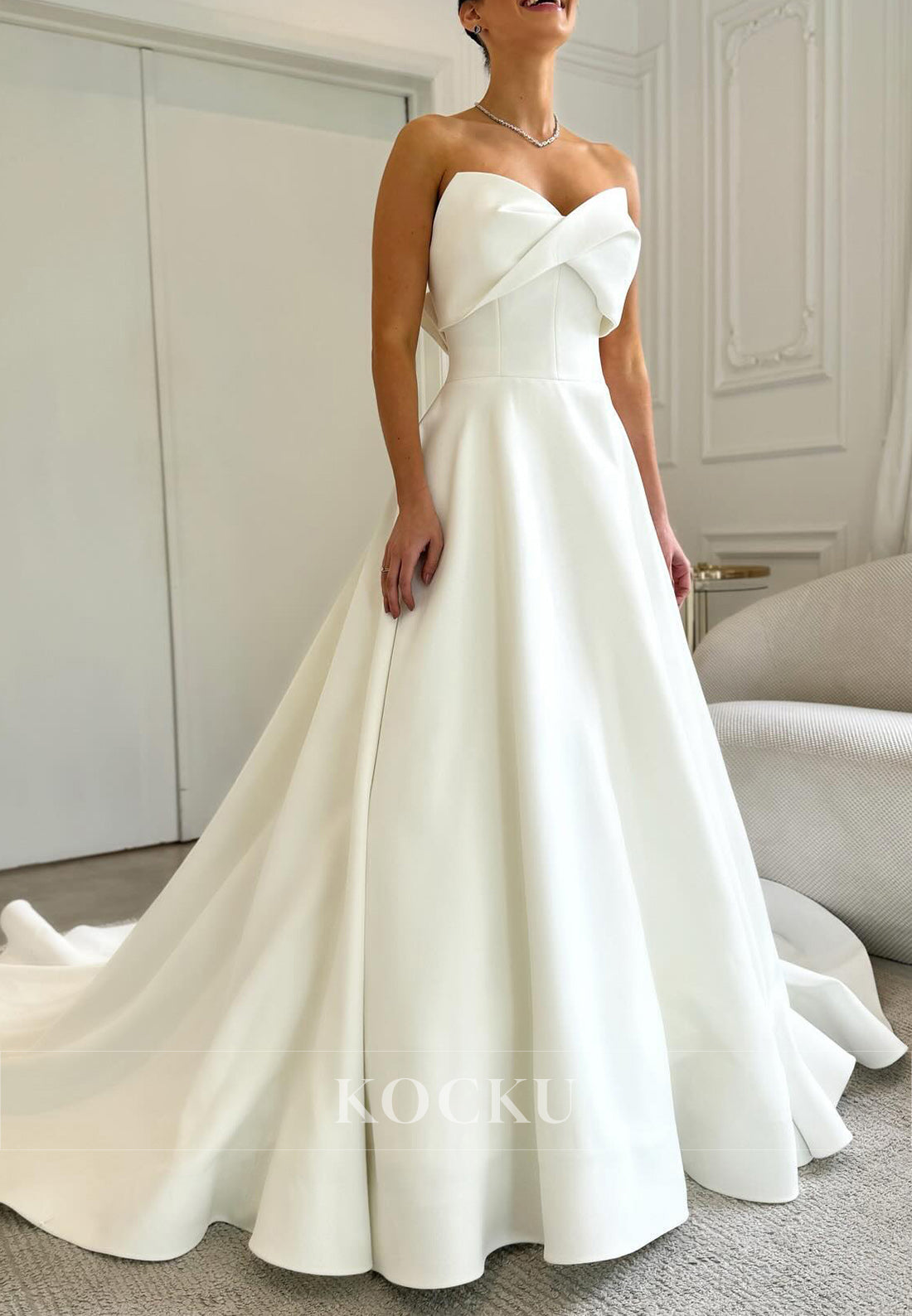 Timeless White Satin Wedding Gown with Bow Embellishment and Full Skirt