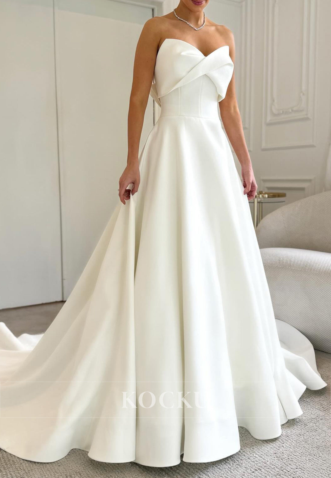 Timeless White Satin Wedding Gown with Bow Embellishment and Full Skirt