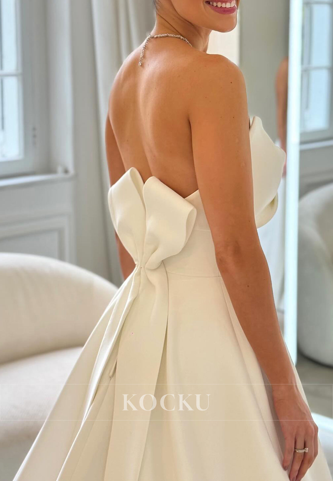 Timeless White Satin Wedding Gown with Bow Embellishment and Full Skirt